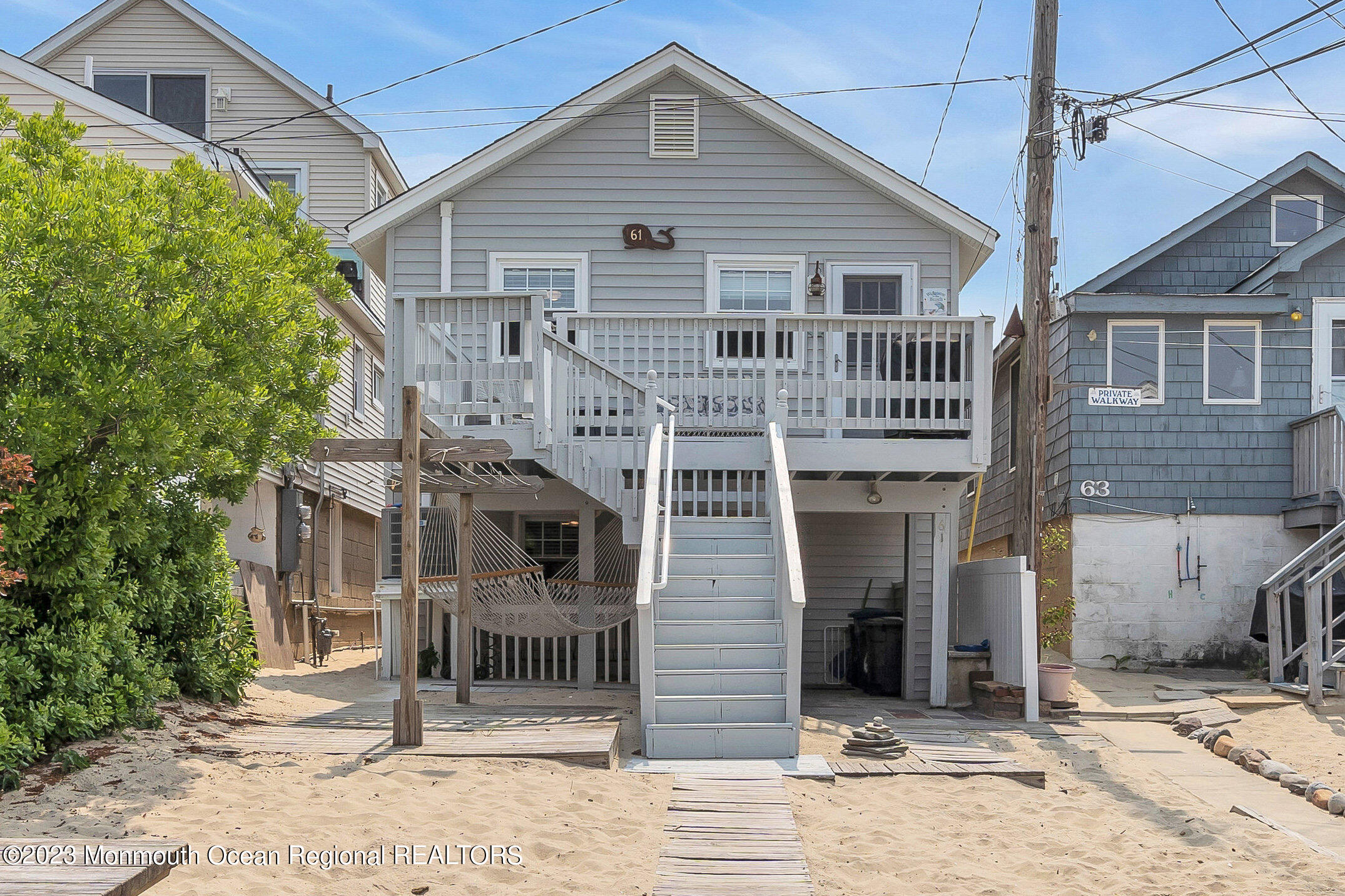 61 Beach Front Manasquan, NJ 08736 - Photo 2 of 20 a front view of a house with a garage