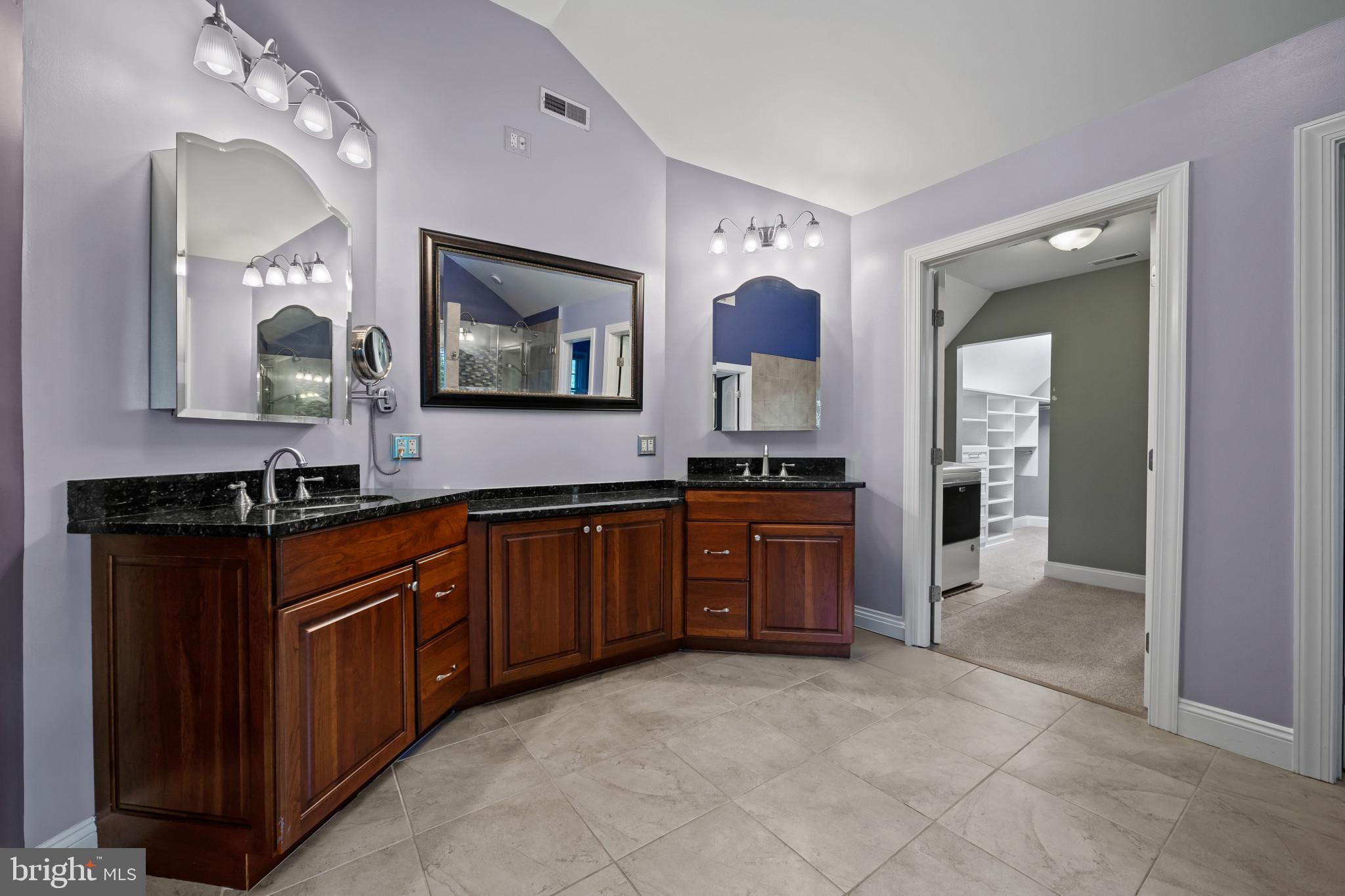 12221 Jerusalem Road Kingsville, MD 21087 - Photo 27 of 66 a spacious bathroom with a granite countertop double vanity sink and a mirror