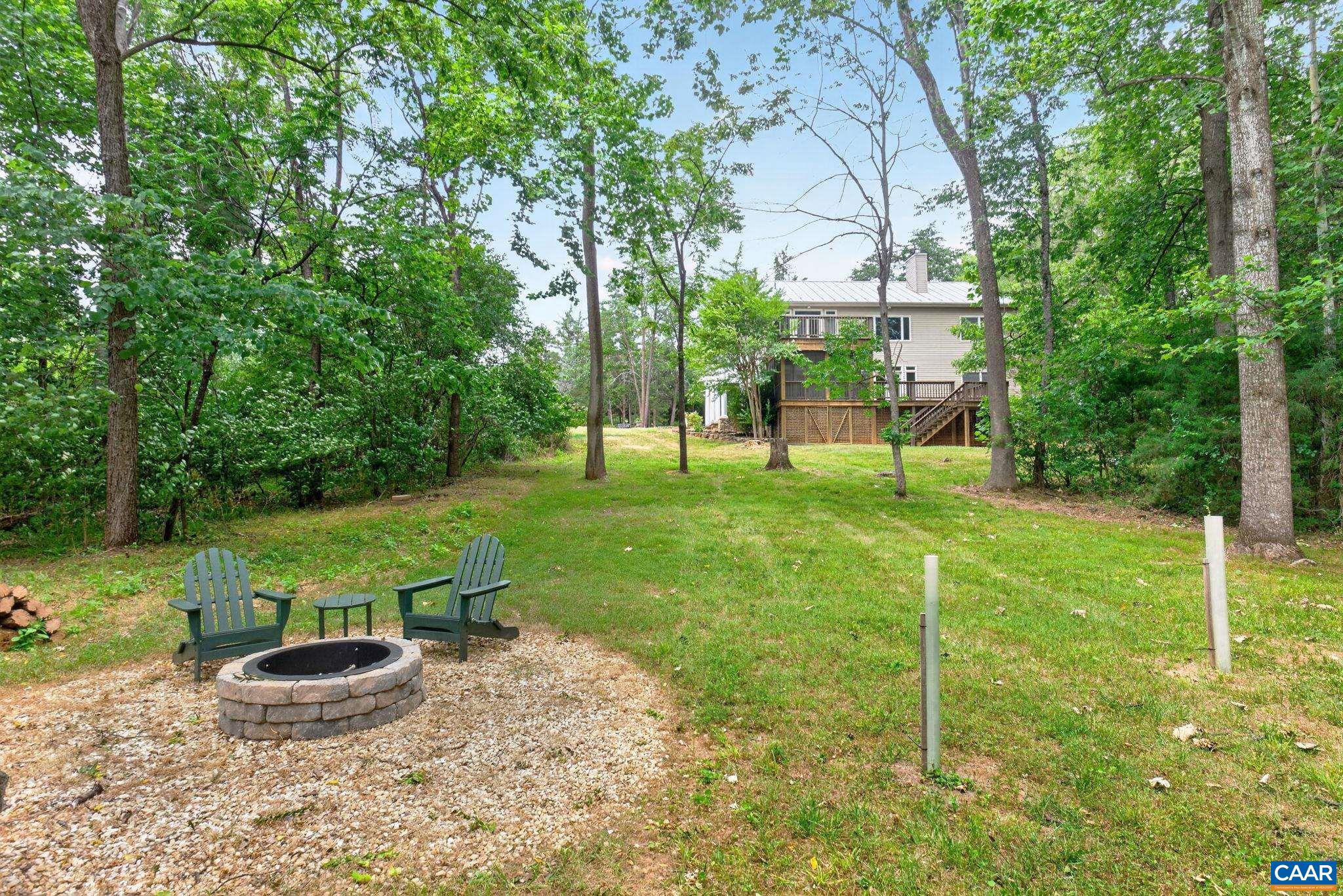 6285 Jarmans Gap Road Crozet, VA 22932 - Photo 45 of 65 a view of a backyard with table and chairs and potted plants