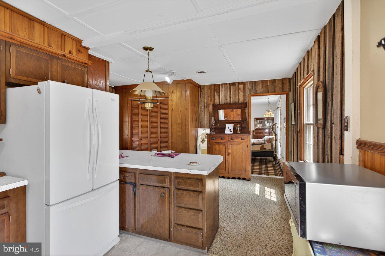 191 Hideaway Farms Road Edinburg, VA 22824 - Photo 22 of 40 a kitchen with a sink a refrigerator a washer and dryer