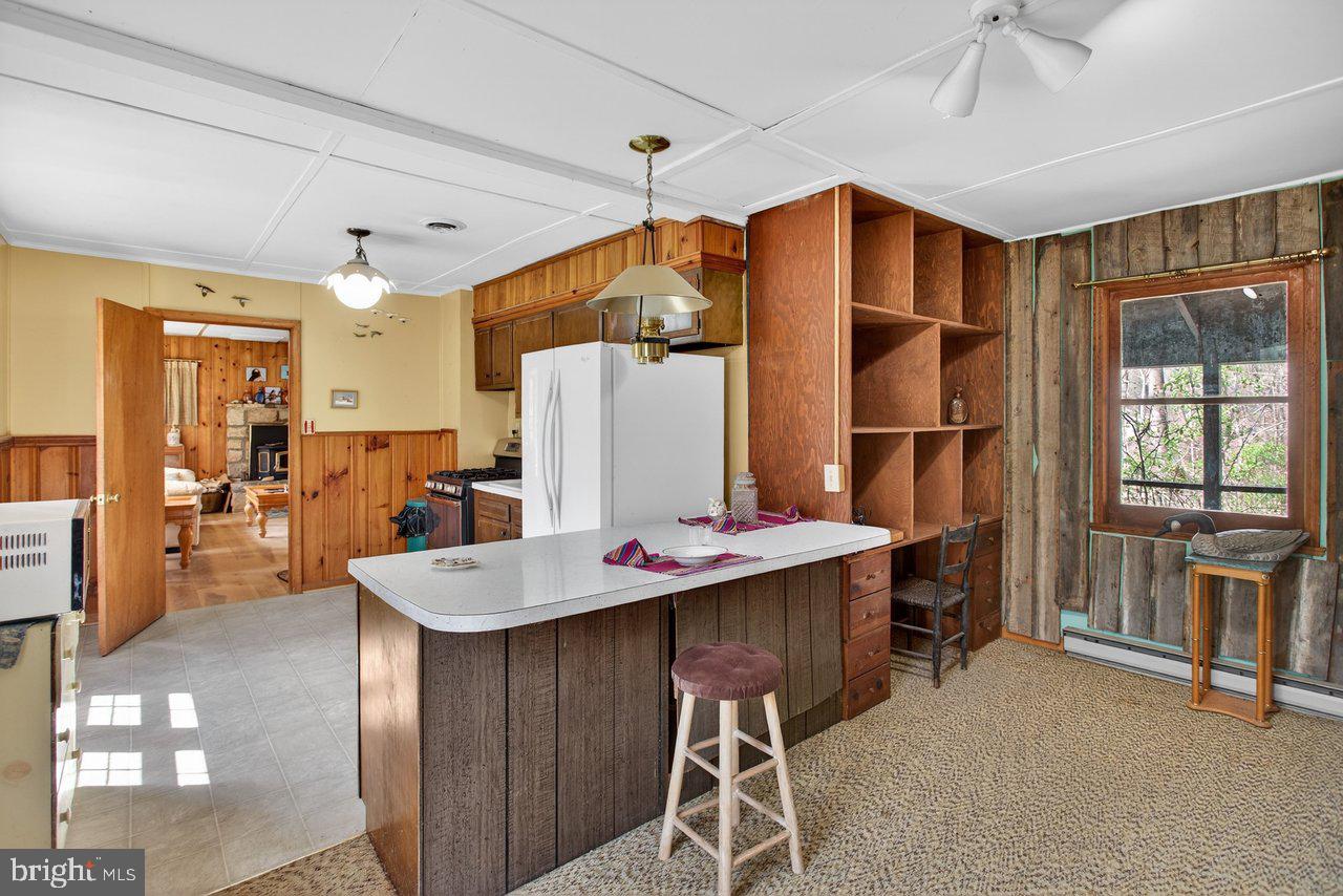 191 Hideaway Farms Road Edinburg, VA 22824 - Photo 23 of 40 a open kitchen with stainless steel appliances granite countertop a refrigerator and a stove top oven