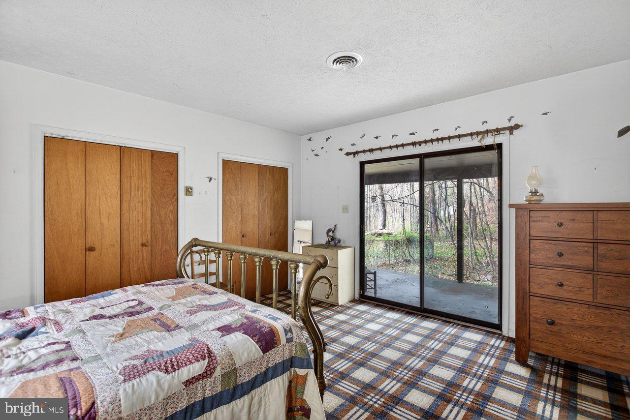 191 Hideaway Farms Road Edinburg, VA 22824 - Photo 29 of 40 a bedroom with a bed and a dresser