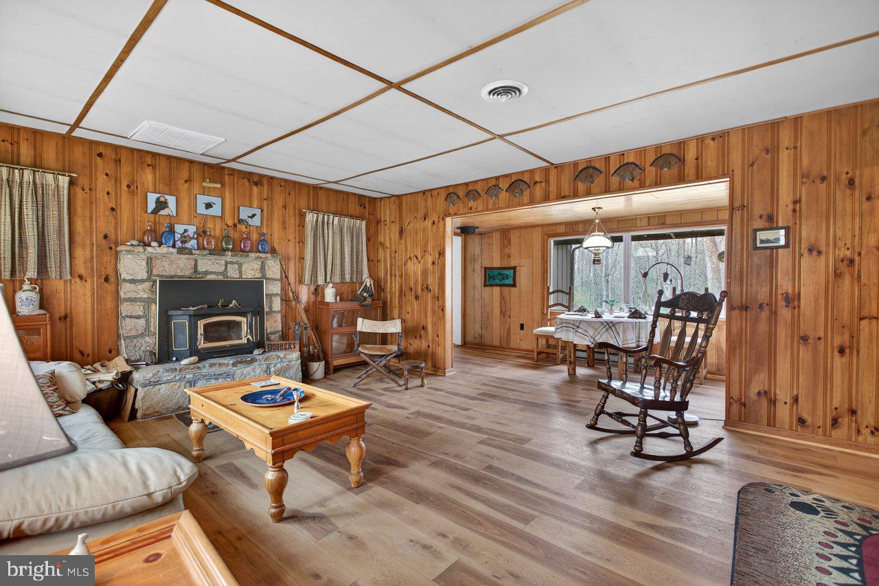 191 Hideaway Farms Road Edinburg, VA 22824 - Photo 6 of 40 a living room with furniture a fireplace and next to a window