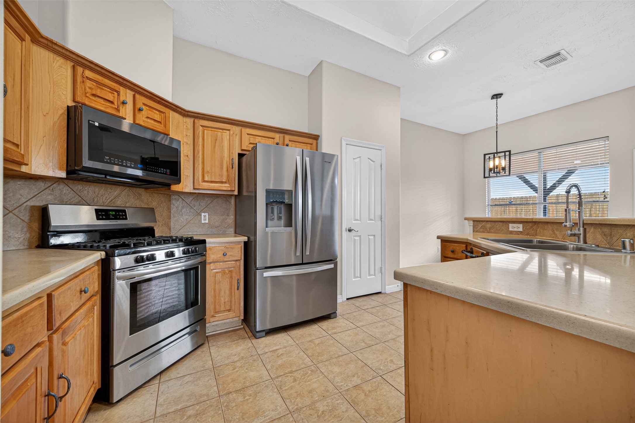 23914 Glengate Drive Spring, TX 77373 - Photo 17 of 49 a kitchen with stainless steel appliances granite countertop a sink a stove top oven and refrigerator