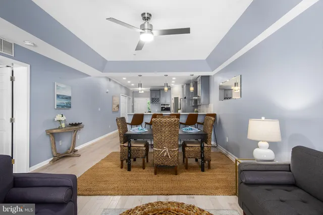 a living room with furniture a rug and a chandelier