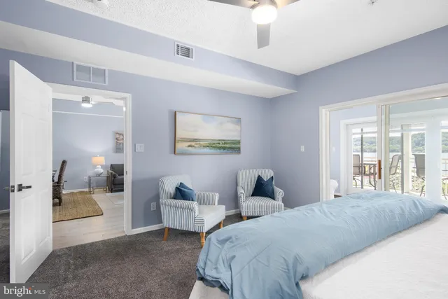 a bedroom with a bed and a large window