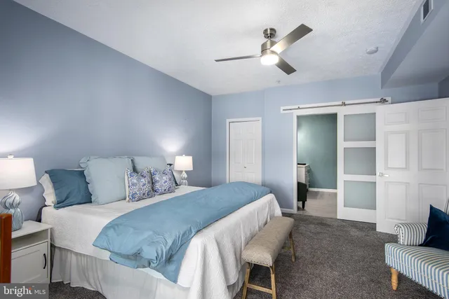 a bedroom with a bed and a lamp