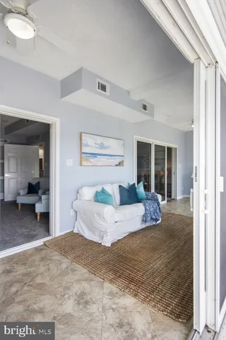 a living room with furniture and large windows