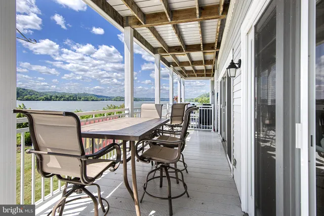 a view of a chairs and table in the balcony