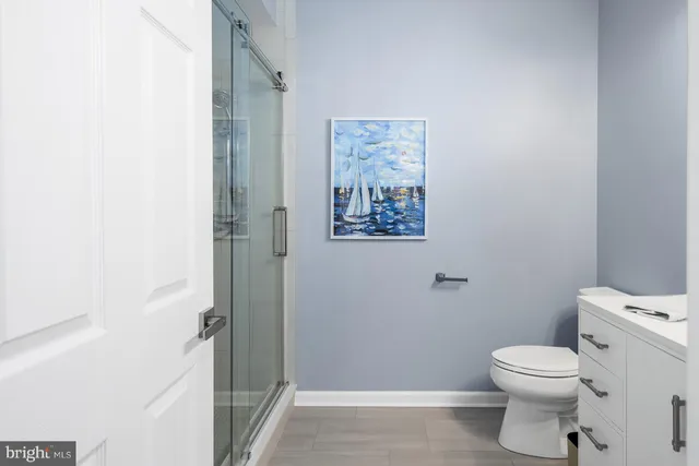 a bathroom with a toilet and a shower