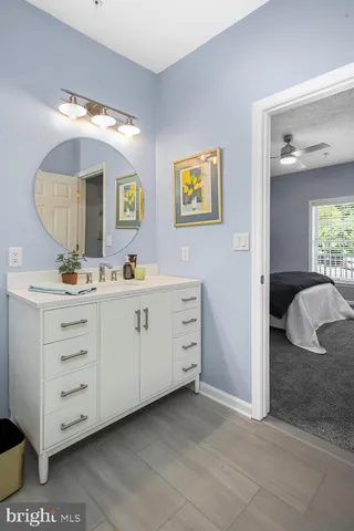 a en suite bathroom with a double vanity sink and a mirror