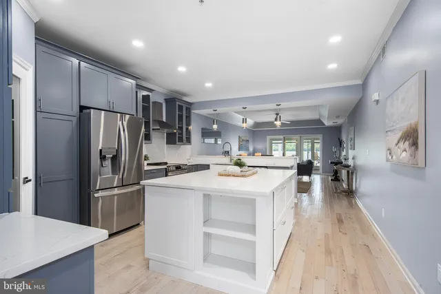 a kitchen with stainless steel appliances a refrigerator sink and stove