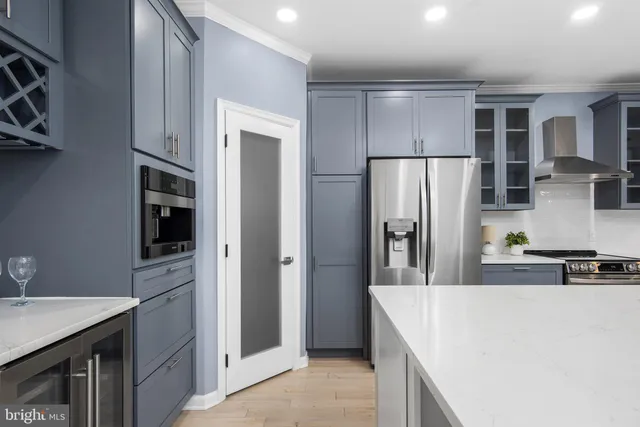 a kitchen with stainless steel appliances granite countertop a refrigerator and a stove