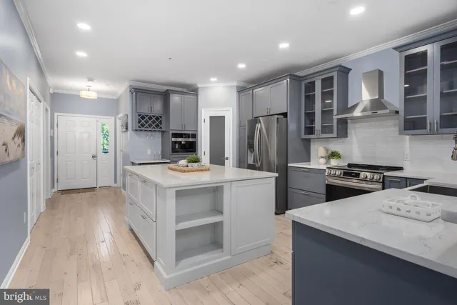 a kitchen with stainless steel appliances kitchen island a refrigerator sink and stove