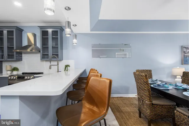 a kitchen with a chair a table and chairs in it