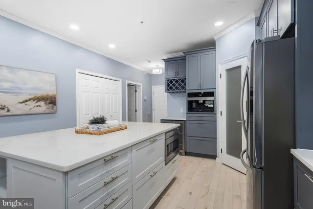 a kitchen with stainless steel appliances a refrigerator and a stove