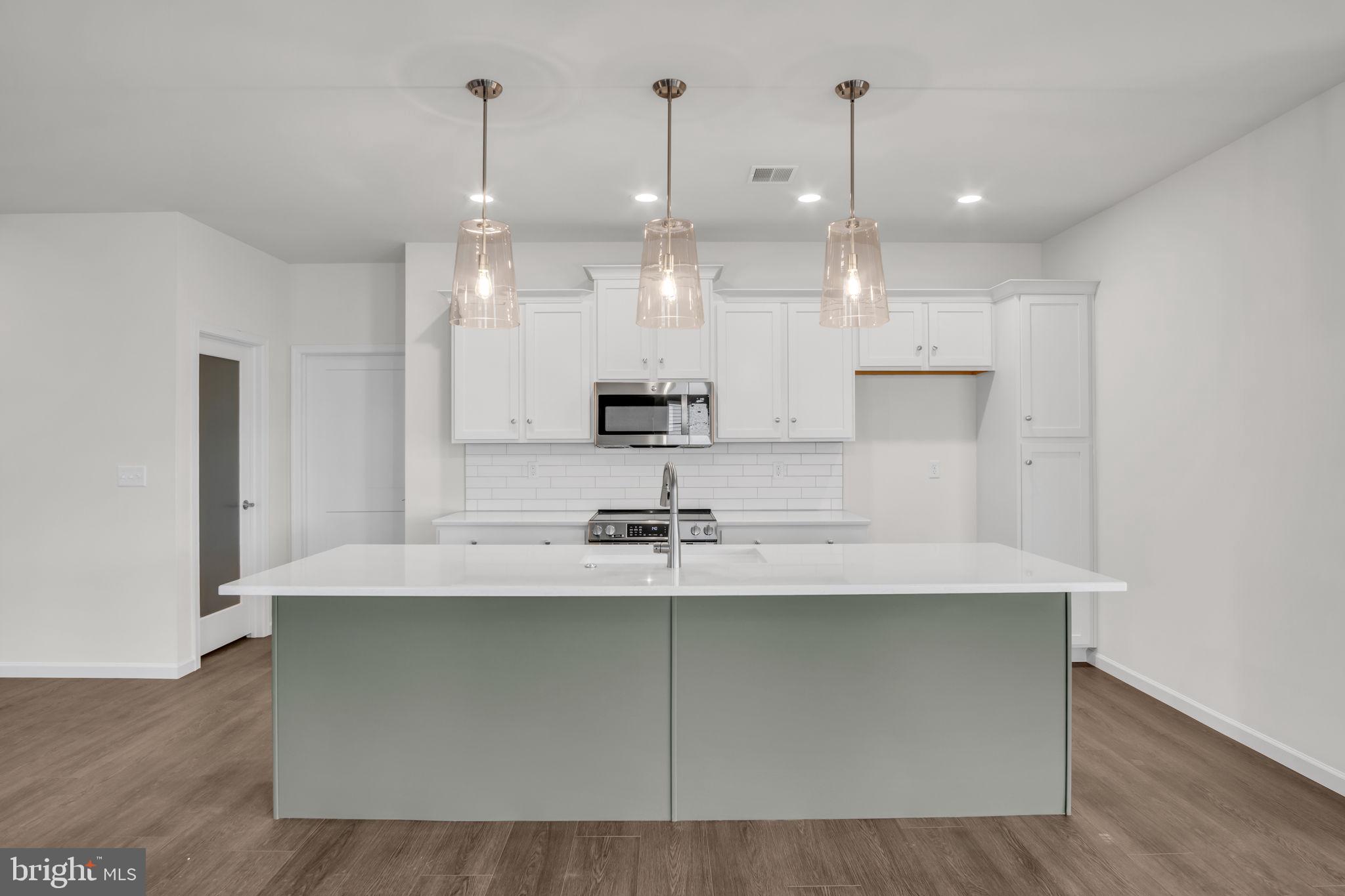 862 Shadowbrooke Dover, PA 17315 - Photo 4 of 10 a kitchen with kitchen island white cabinets and refrigerator