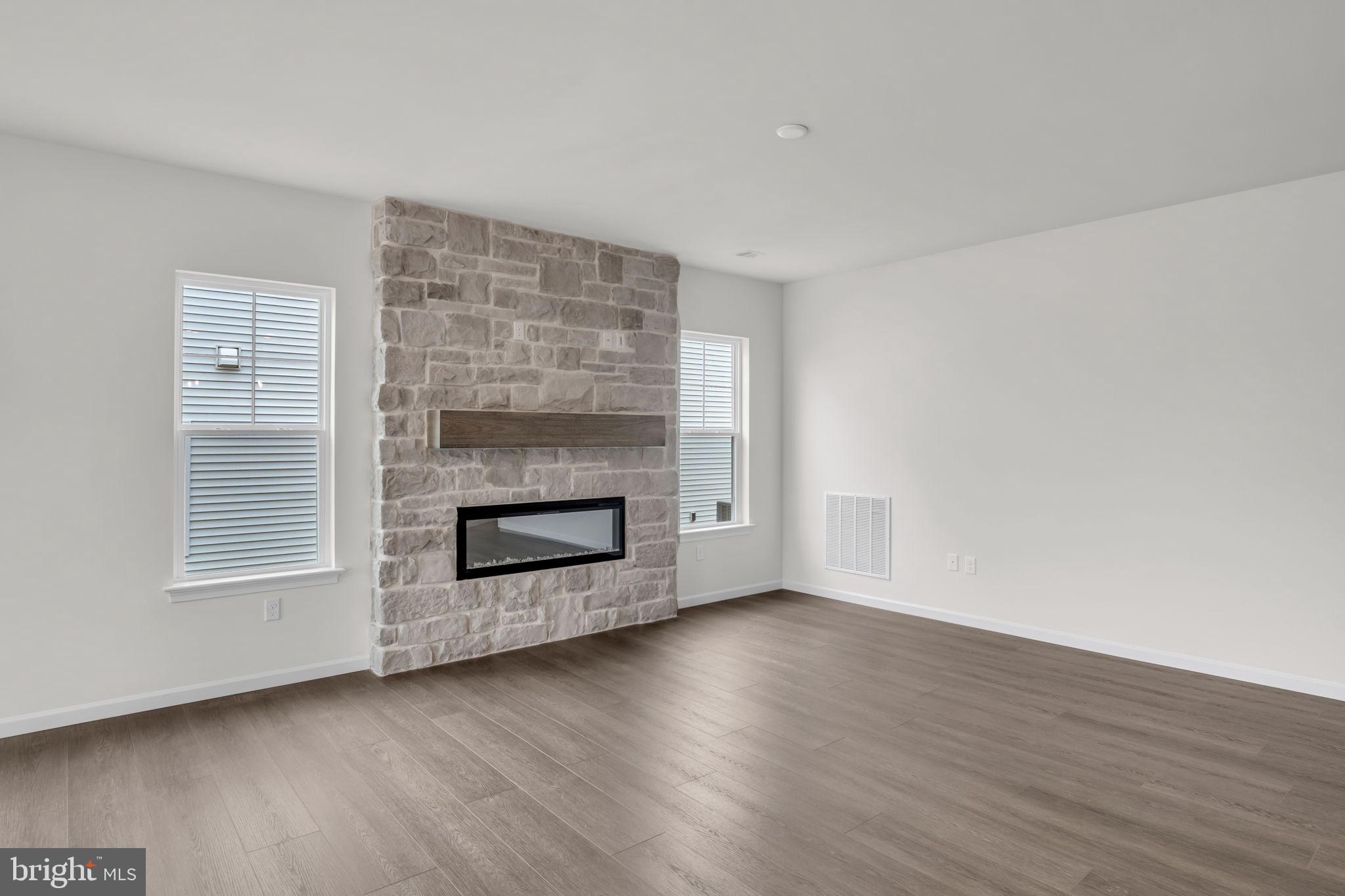 862 Shadowbrooke Dover, PA 17315 - Photo 5 of 10 an empty room with wooden floor and fireplace