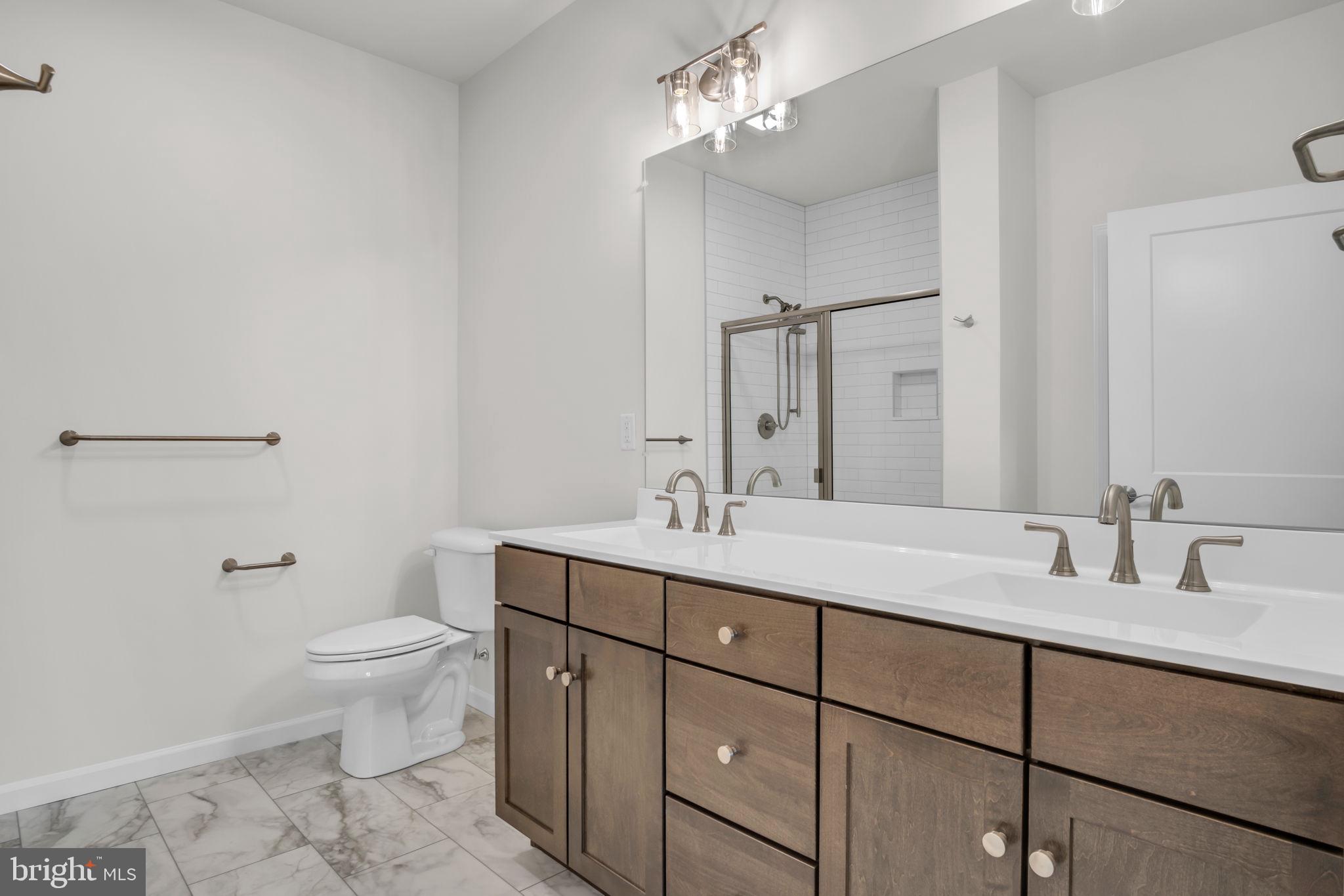 862 Shadowbrooke Dover, PA 17315 - Photo 8 of 10 a bathroom with a sink a toilet a mirror and shower