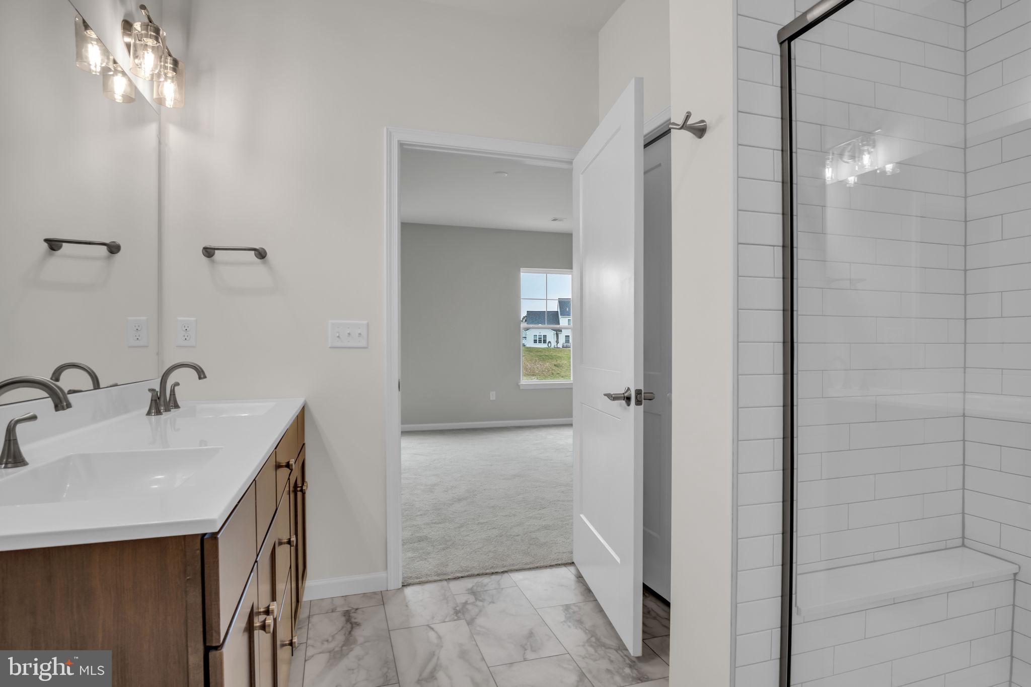 862 Shadowbrooke Dover, PA 17315 - Photo 9 of 10 a bathroom with a double vanity sink a large mirror and shower