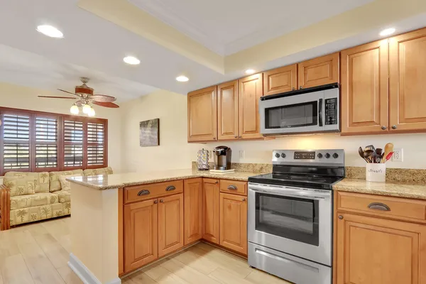 a kitchen with stainless steel appliances granite countertop a stove sink microwave and cabinets
