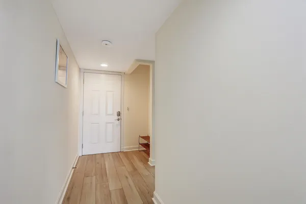 a view of a room with wooden floor