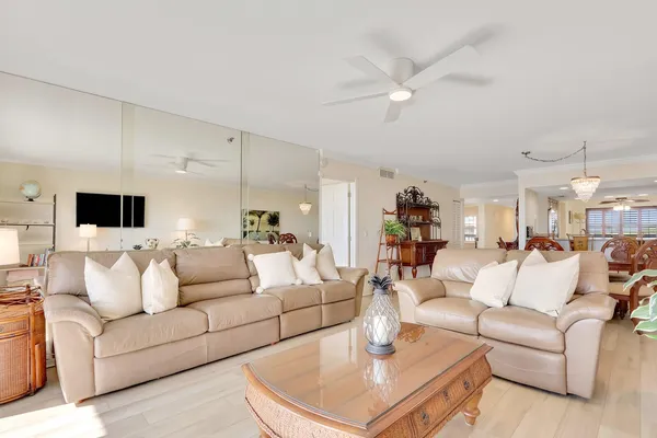 a living room with furniture and a chandelier