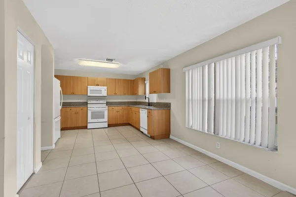a kitchen with granite countertop a sink stainless steel appliances and cabinets