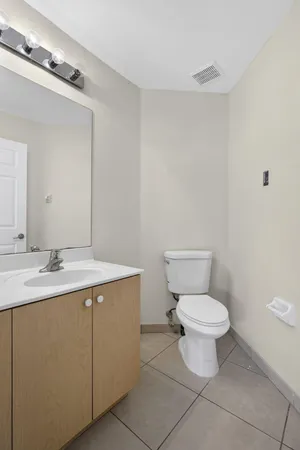 a bathroom with a tub a sink and mirror