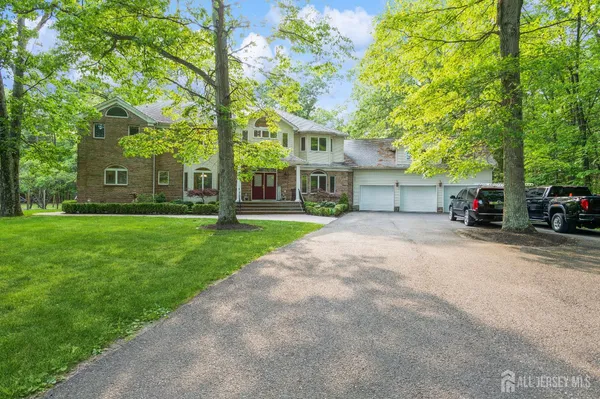 a view of a house with a tree in front of it