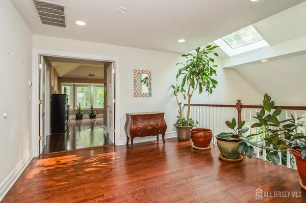 a hallway with a potted plant and a table