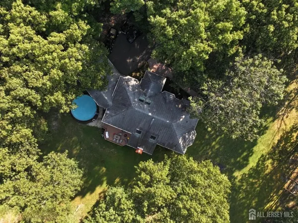 an aerial view of a house with a yard and lake view