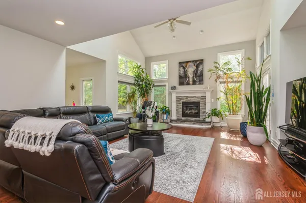 a living room with furniture a flat screen tv and a fireplace