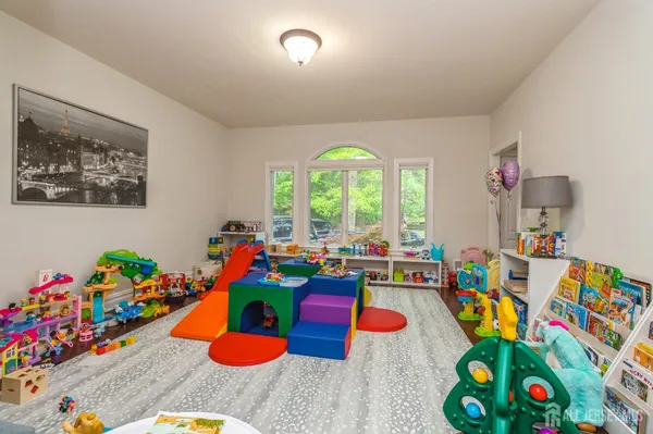 a play room with toys and a floor to ceiling window