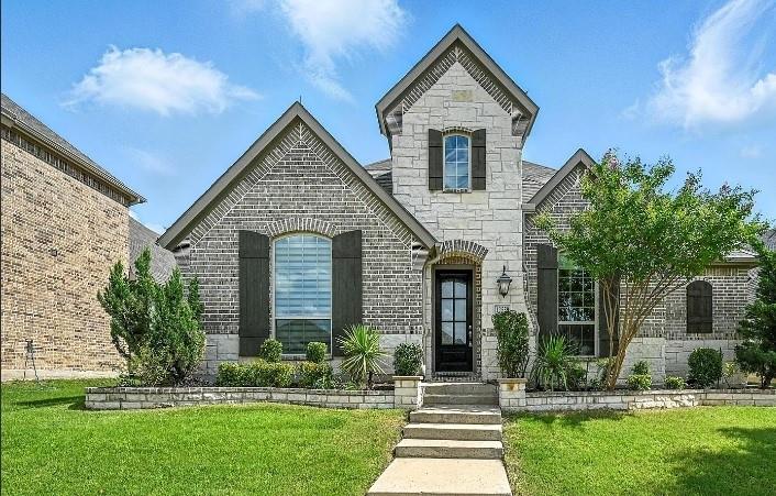 12559 Ravine Creek Road Frisco, TX 75035 - Photo 1 of 33 French country home featuring stone siding, a front lawn, and brick siding