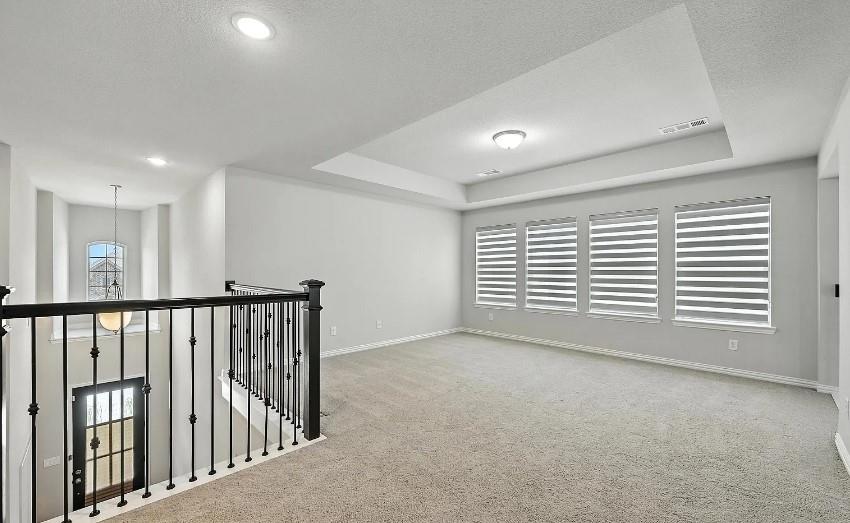 12559 Ravine Creek Road Frisco, TX 75035 - Photo 11 of 33 Spare room with a raised ceiling, light carpet, a textured ceiling, and recessed lighting