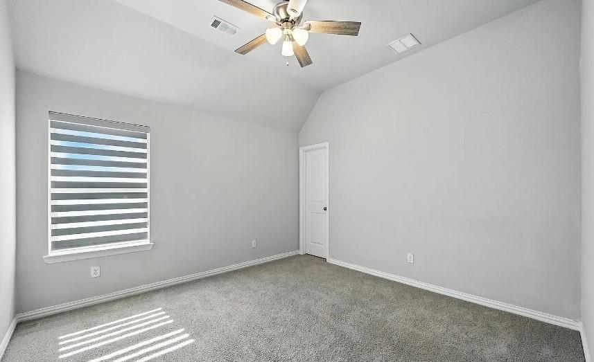 12559 Ravine Creek Road Frisco, TX 75035 - Photo 13 of 33 Carpeted spare room featuring a ceiling fan and lofted ceiling