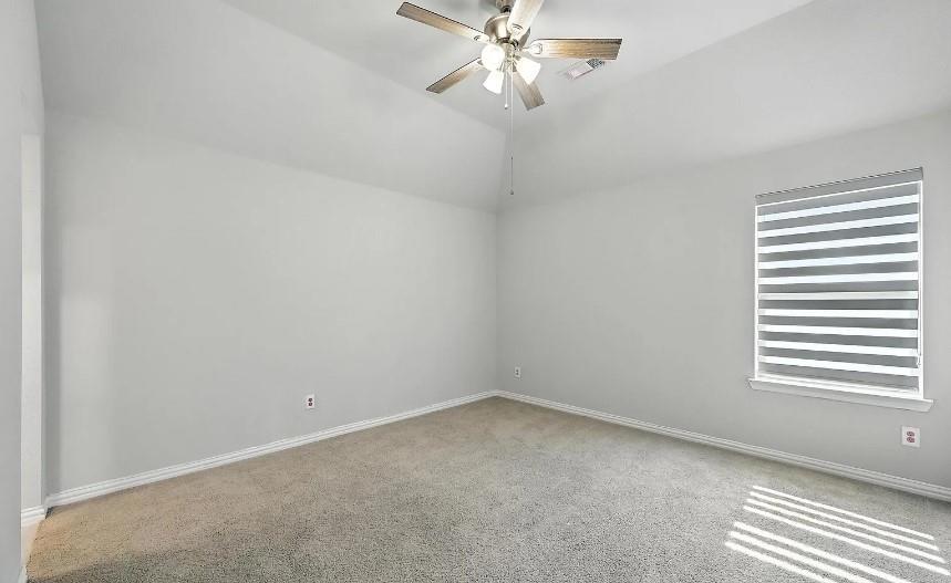 12559 Ravine Creek Road Frisco, TX 75035 - Photo 14 of 33 Empty room featuring light colored carpet, lofted ceiling, and ceiling fan
