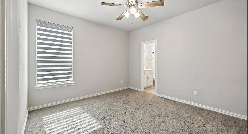 12559 Ravine Creek Road Frisco, TX 75035 - Photo 15 of 33 Spare room featuring a ceiling fan and light colored carpet