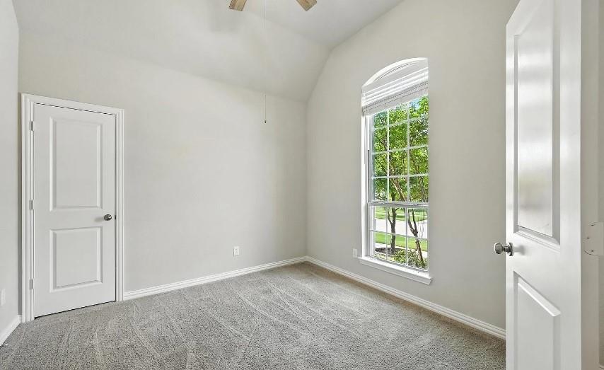 12559 Ravine Creek Road Frisco, TX 75035 - Photo 17 of 33 Spare room featuring light colored carpet, vaulted ceiling, and ceiling fan