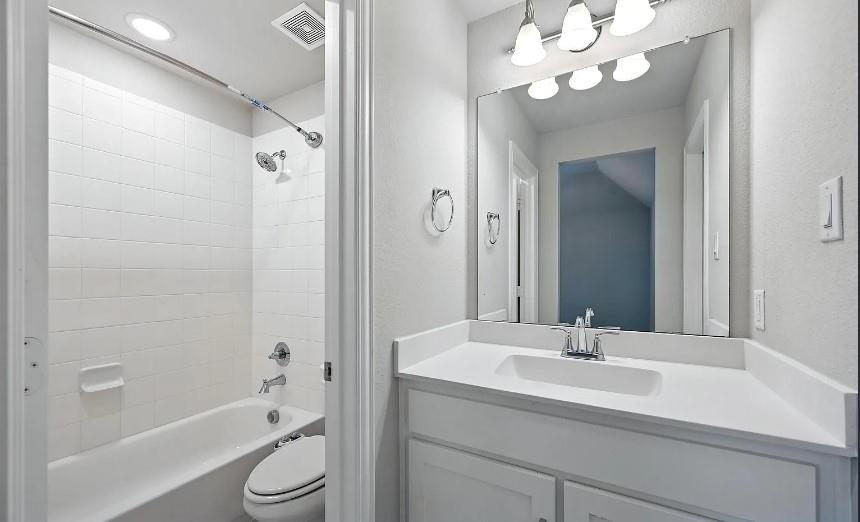 12559 Ravine Creek Road Frisco, TX 75035 - Photo 20 of 33 Bathroom with vanity, shower / bath combination, and recessed lighting