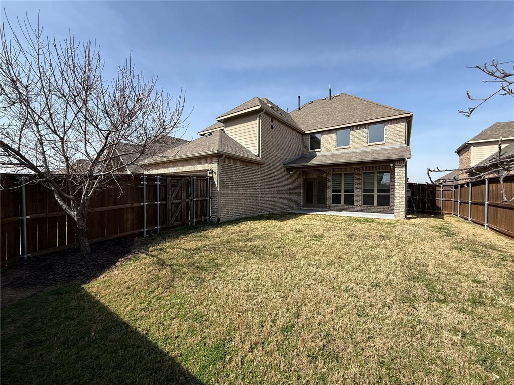 12559 Ravine Creek Road Frisco, TX 75035 - Photo 25 of 33 Rear view of property featuring a patio area, brick siding, a fenced backyard, and a shingled roof