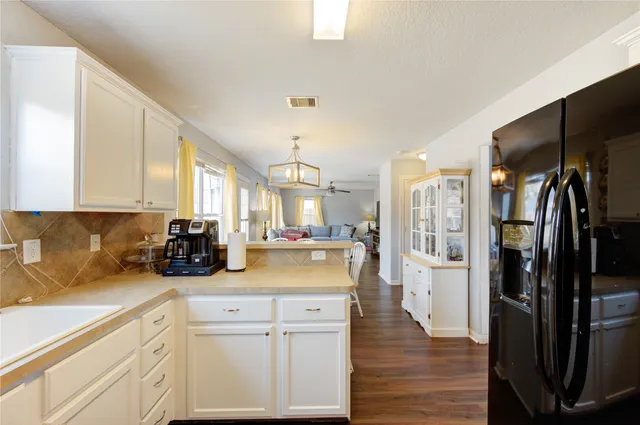a kitchen with stainless steel appliances a refrigerator sink and cabinets