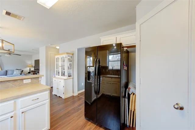 a view of kitchen with refrigerator and window