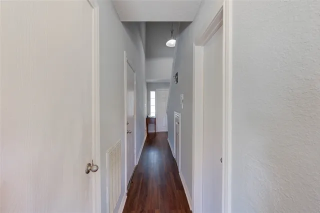 a view of a hallway with wooden floor