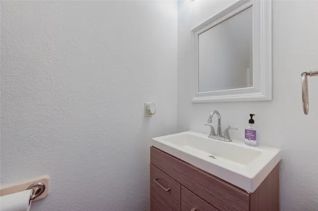 a bathroom with a sink vanity and a mirror