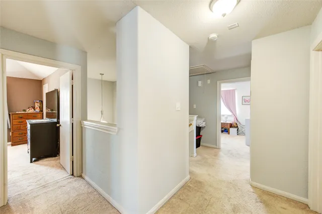 a view of a hallway with furniture and a livingroom