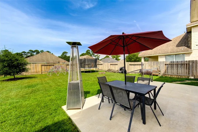 a view of an chairs and table in the yard