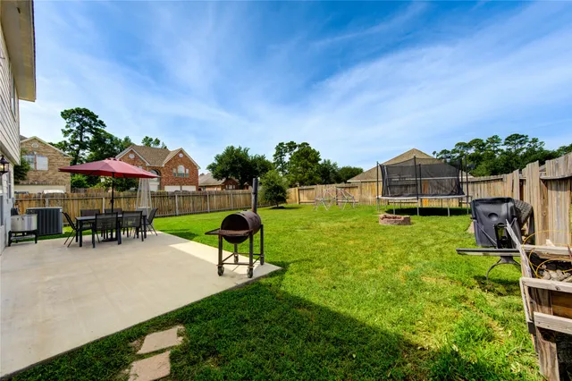a view of a house with backyard porch and sitting area