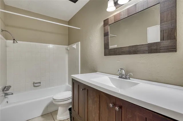 a bathroom with a sink toilet a mirror and shower